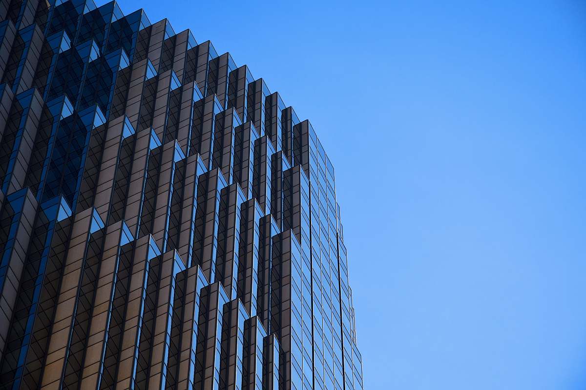 office building low-angle photography of building under blue calm sky san francisco